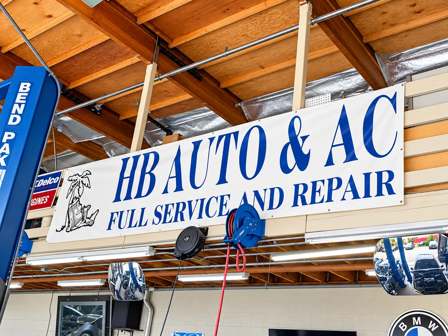 HB Auto & AC Full Service and Repair banner hanging in the shop