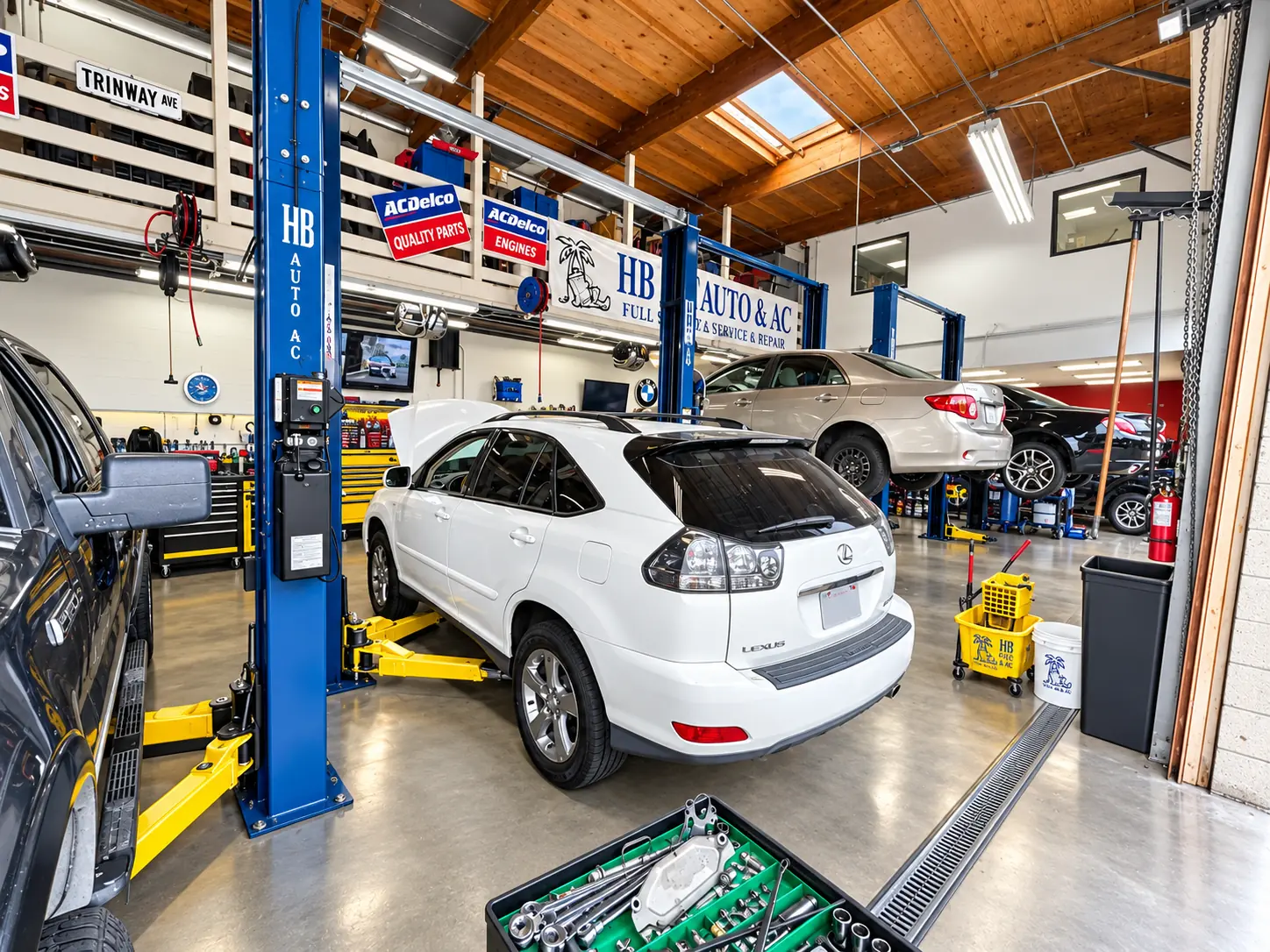 SUV raised on a lift in the HB Auto & AC service bay